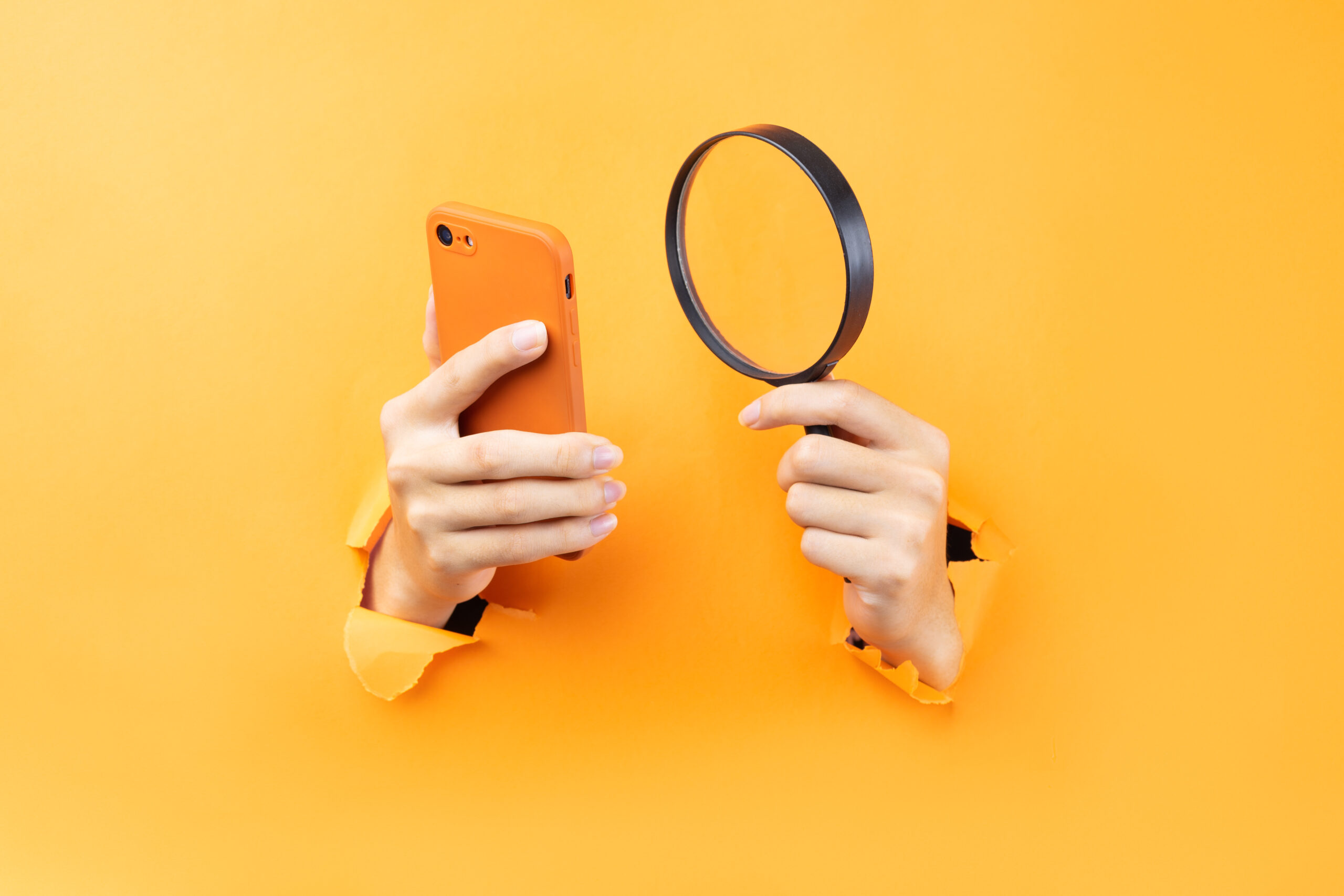 vecteezy hand holding magnifying glass and phone protruding from background 2871065 scaled